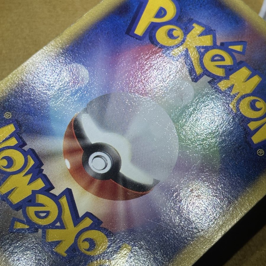 Same Japanese Pokémon card back after dent & in-dent removal by Pokejem
