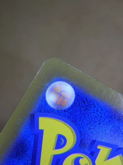 Same card after lifted edge repair by Pokejem