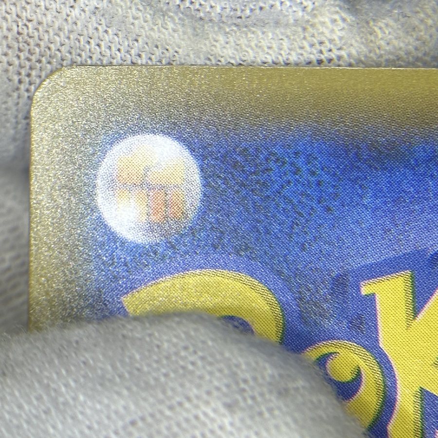 Same Japanese Pokémon card after edge whitening repair by Pokejem